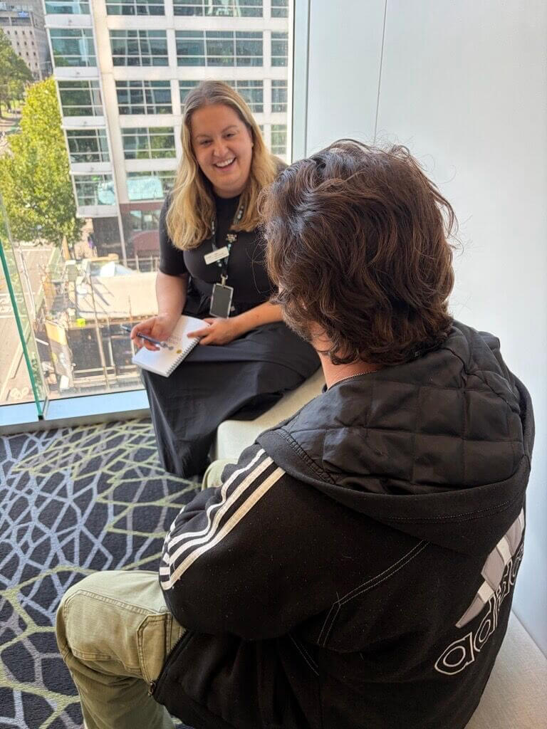 Two people sitting opposite each other and talking