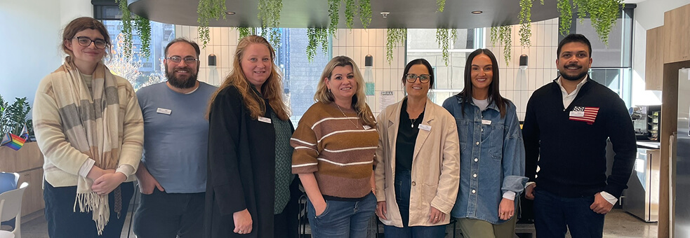 Photo of some of the Outcomes Connect Australia team smiling to camera